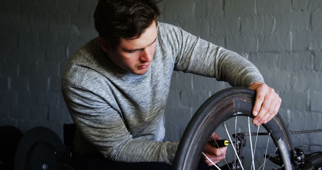 Man Repairing Bicycle Tire in Workshop - Free Images, Stock Photos and Pictures on Pikwizard.com