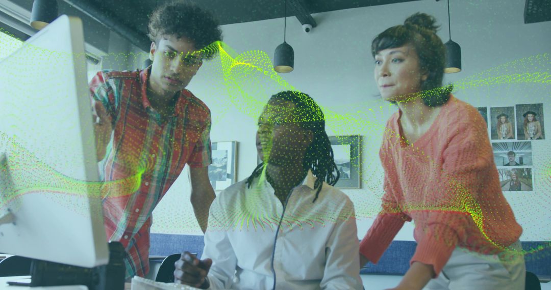 Diverse Team Analyzing Data on Computer Monitor in Modern Office