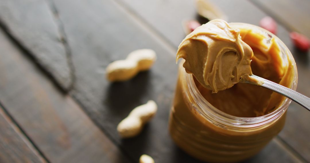 Close Up of Creamy Peanut Butter on Rustic Wooden Table