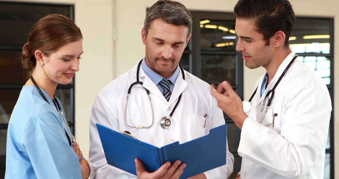 Medical Team Discussing Patient's Chart in Hospital - Free Images, Stock Photos and Pictures on Pikwizard.com