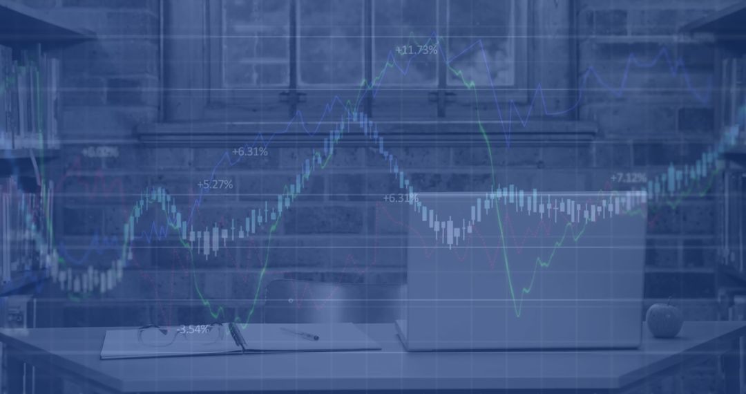 Overlay of Financial Graphs on Laptop in Modern Office Environment