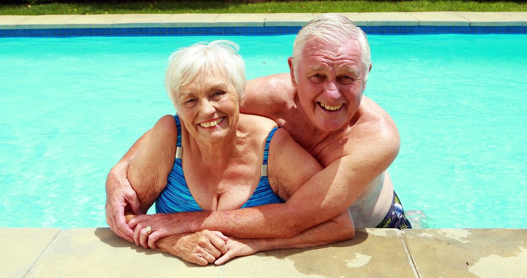 Happy Senior Couple Embracing While Swimming in Pool on Sunny Day - Free Images, Stock Photos and Pictures on Pikwizard.com