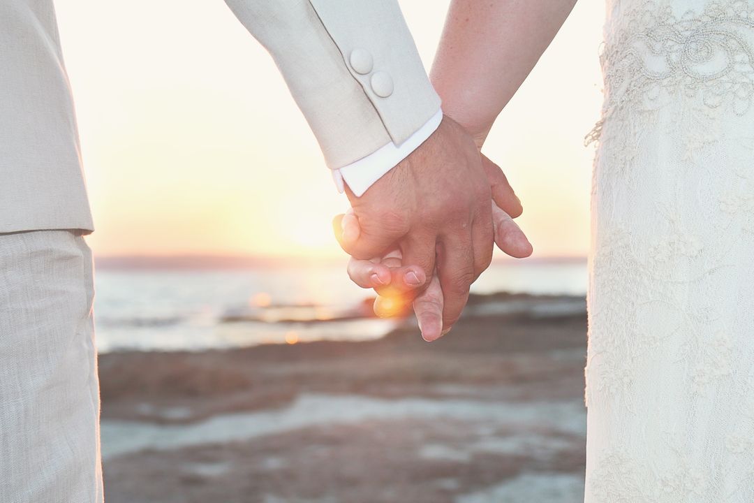 Close Up of Bride and Groom Holding Hands During Sunset Beach Wedding - Free Images, Stock Photos and Pictures on Pikwizard.com