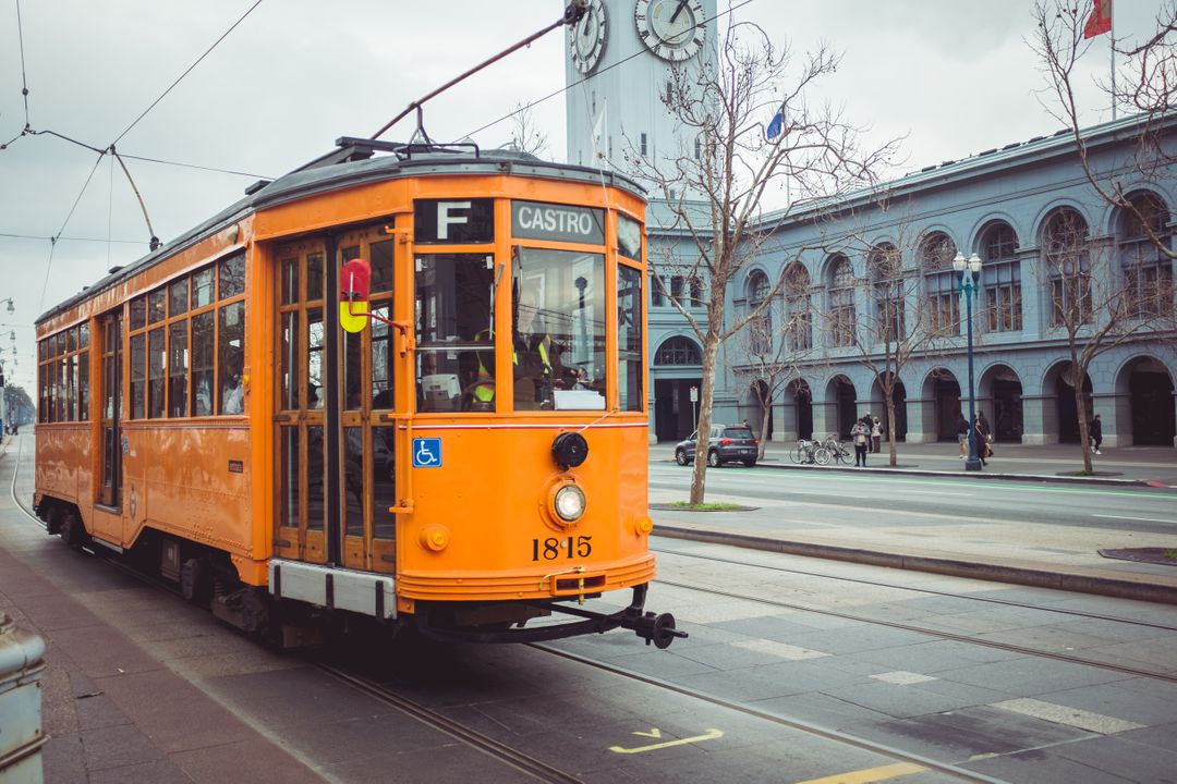 Historic Orange Streetcar in Urban Cityscape - Free Images, Stock Photos and Pictures on Pikwizard.com