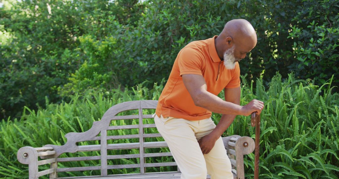 Senior Man with Cane Sitting on Wooden Bench in Garden - Free Images, Stock Photos and Pictures on Pikwizard.com