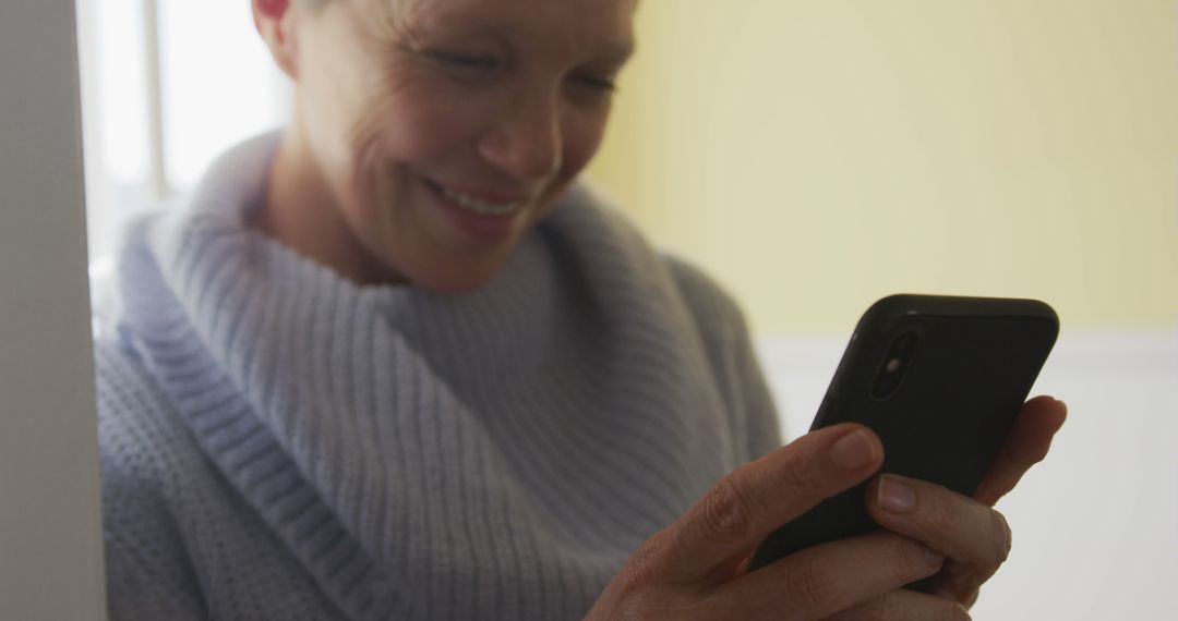 Senior Woman Smiling While Using Smartphone - Free Images, Stock Photos and Pictures on Pikwizard.com