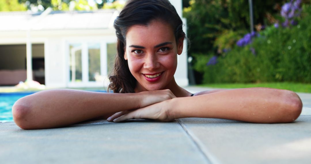 Smiling Young Woman Relaxing by Swimming Pool on Sunny Day - Free Images, Stock Photos and Pictures on Pikwizard.com