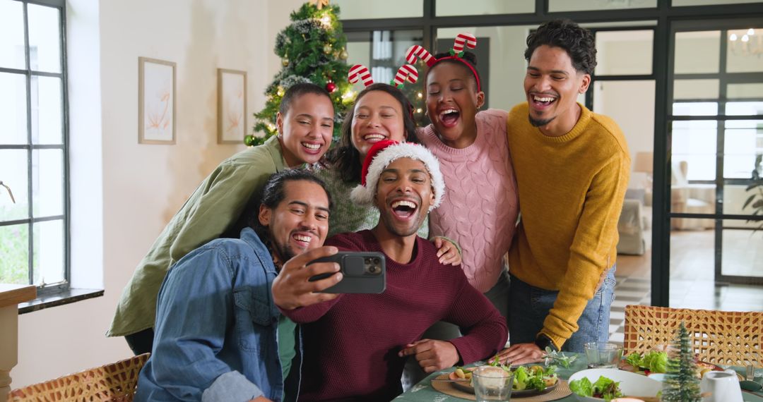 Diverse Friends Taking Holiday Selfie by Christmas Tree