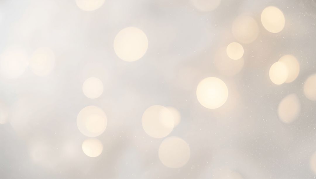 Soft Golden Bokeh Lights on Pale Beige Background with Subtle Sparkle and Ambient Warmth