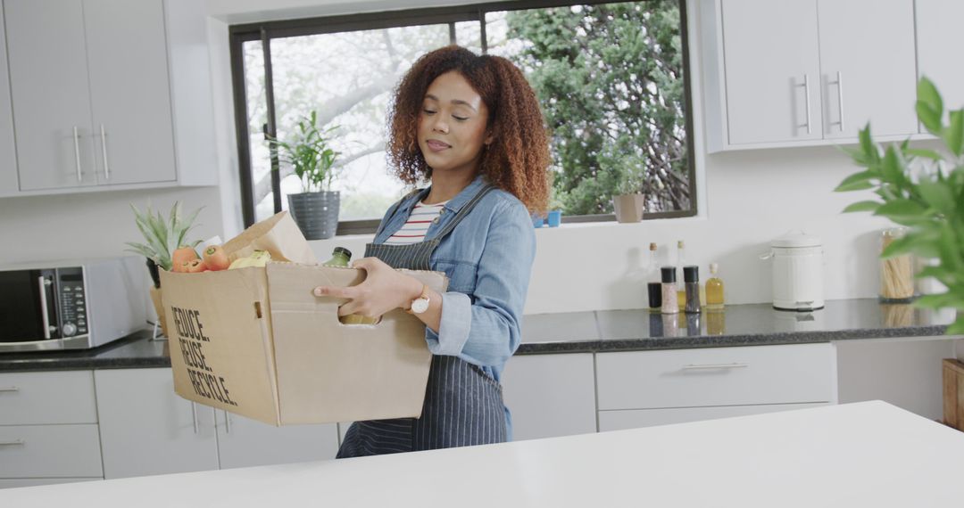 Smiling Woman Unpacking Groceries in Modern Kitchen - Free Images, Stock Photos and Pictures on Pikwizard.com