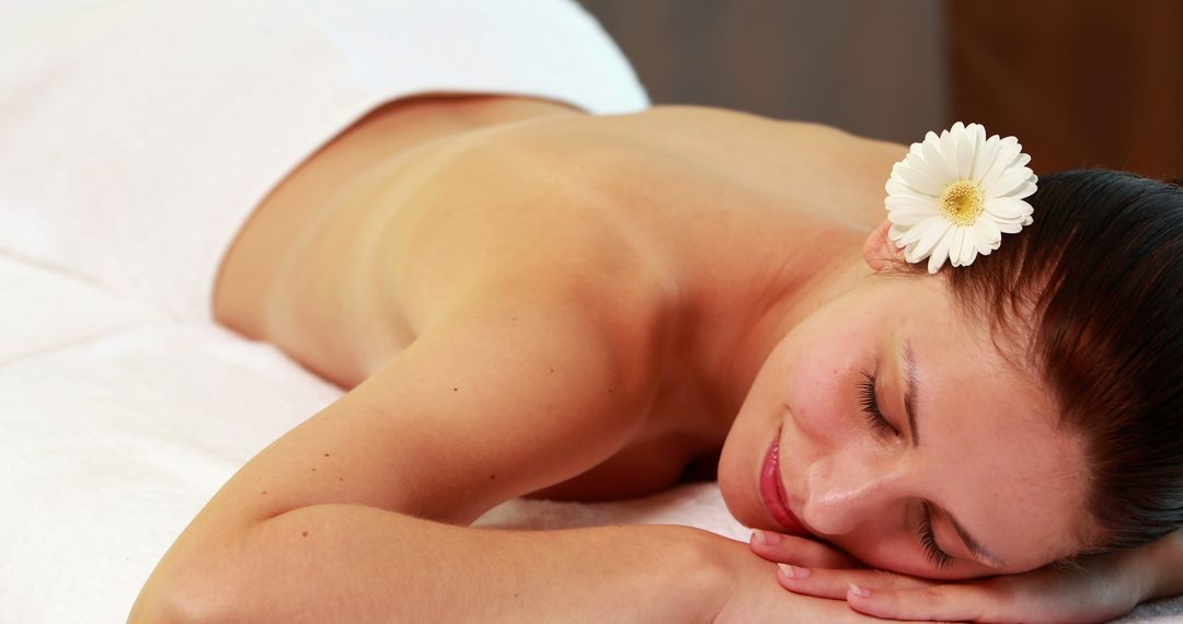 Woman Relaxing with a Flower in Her Hair at a Spa - Free Images, Stock Photos and Pictures on Pikwizard.com