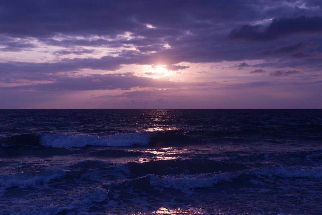 Vibrant Purple Ocean Sunset with Calm Waves and Cloudy Sky - Free Images, Stock Photos and Pictures on Pikwizard.com