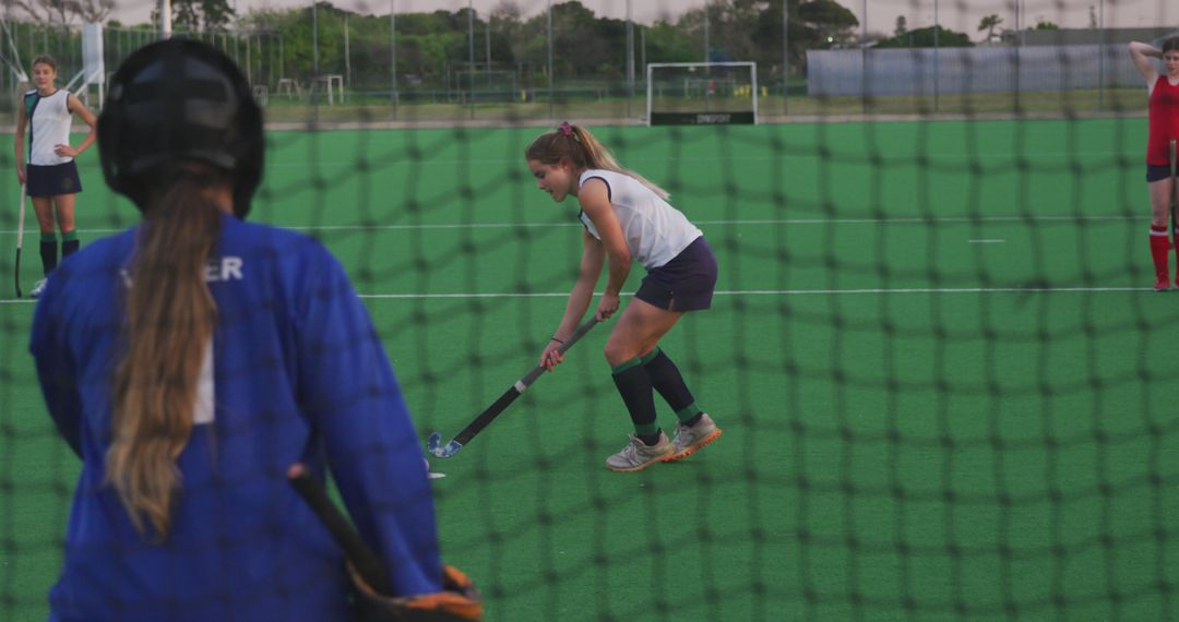 Female Field Hockey Team Practicing on Turf Field - Free Images, Stock Photos and Pictures on Pikwizard.com