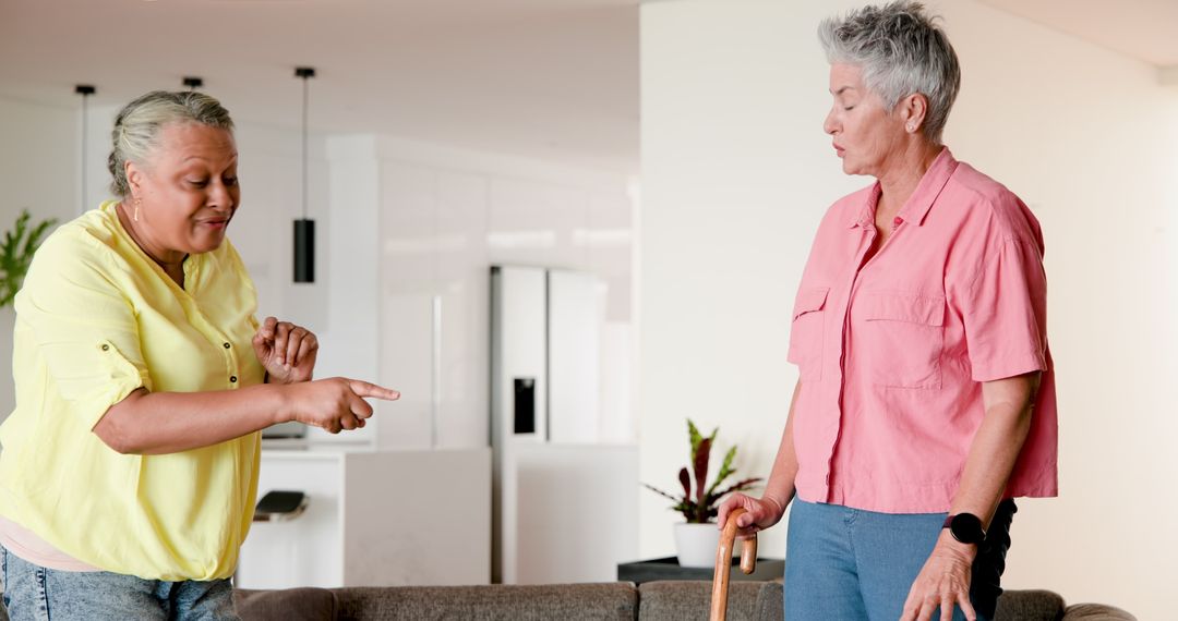 Smiling Leisurely Multiracial Lesbian Couple Communicating at Home