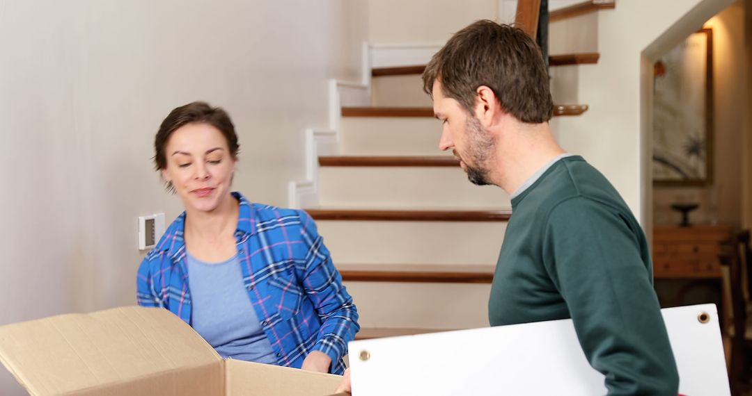 Couple Moving Boxes Together in New Home