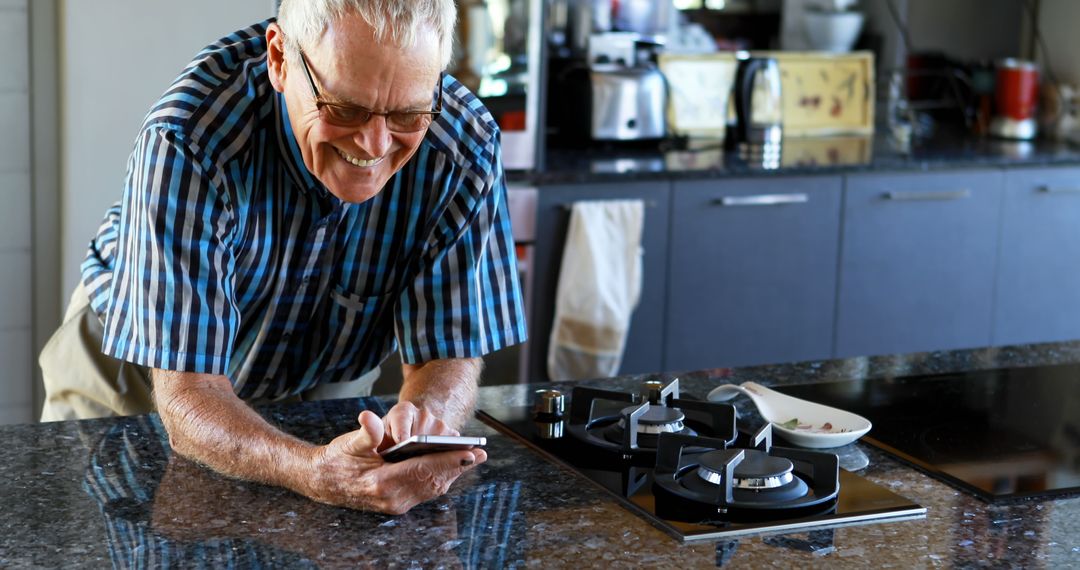 Elderly Man Enjoying Technology in Modern Kitchen - Free Images, Stock Photos and Pictures on Pikwizard.com