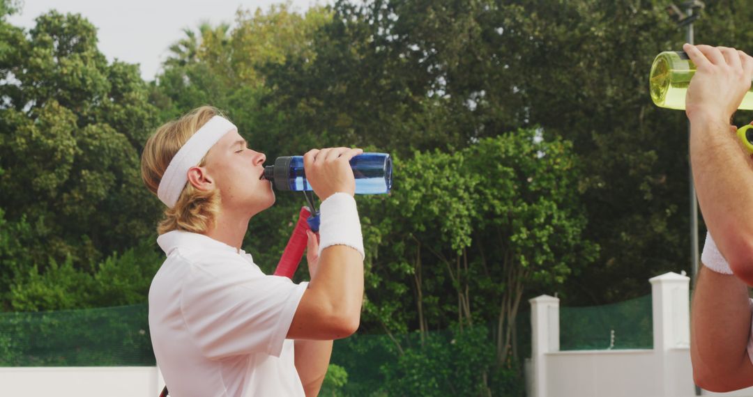 Male Tennis Players Drinking Water During Break - Free Images, Stock Photos and Pictures on Pikwizard.com