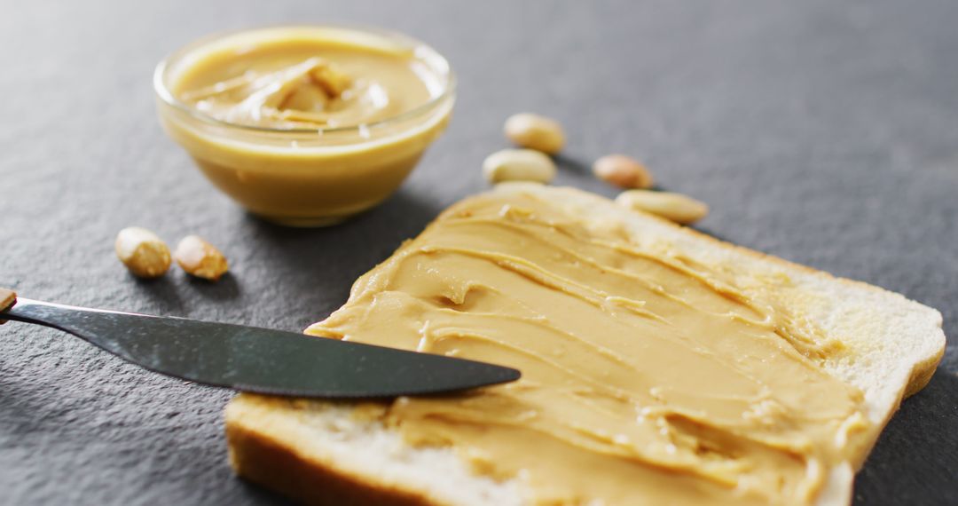 Peanut Butter Spread on Toast with Glass Bowl
