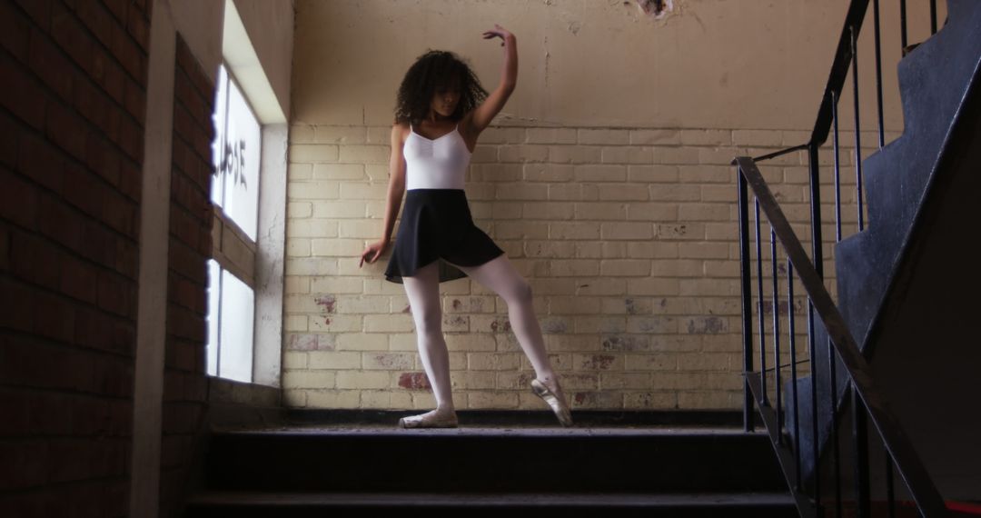Dancer Performing in Abandoned Staircase for Urban Expression