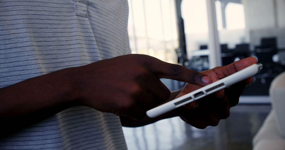Hands of Person Engaged with Smartphone in Office Setting
