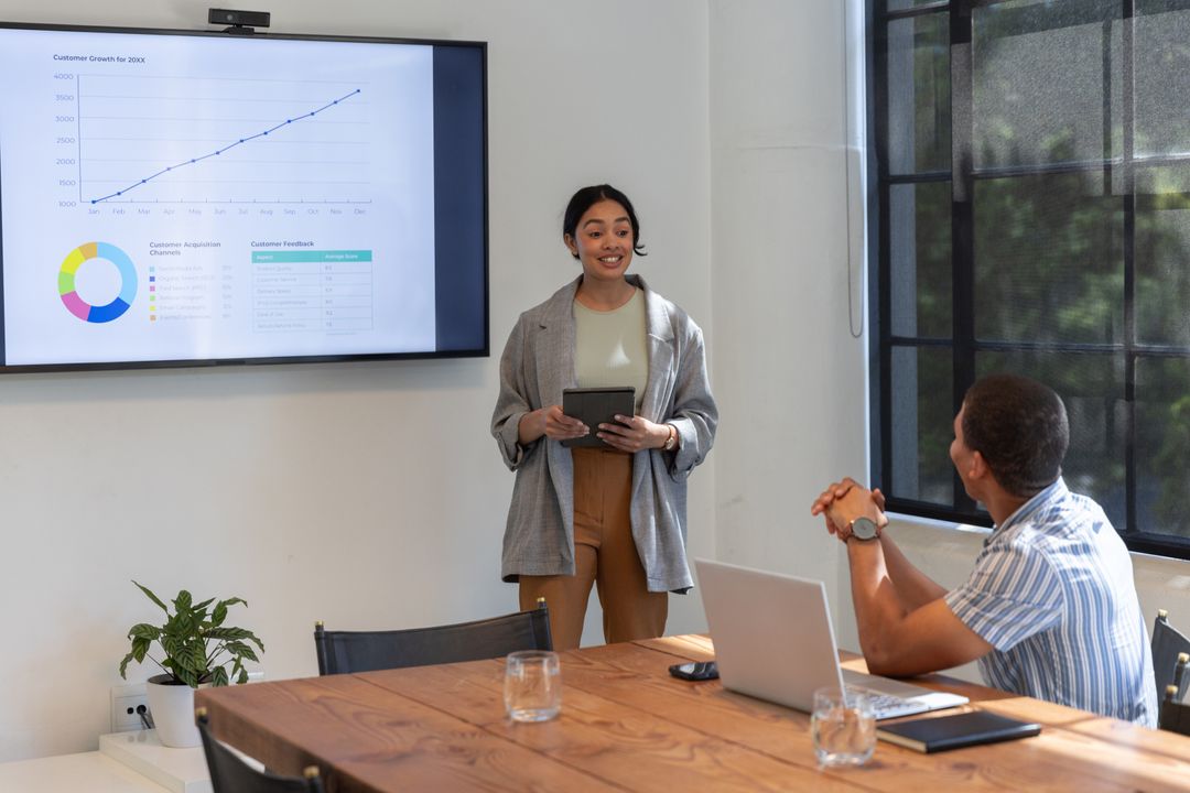Diverse Team Analyzing Growth Chart in Conference Room