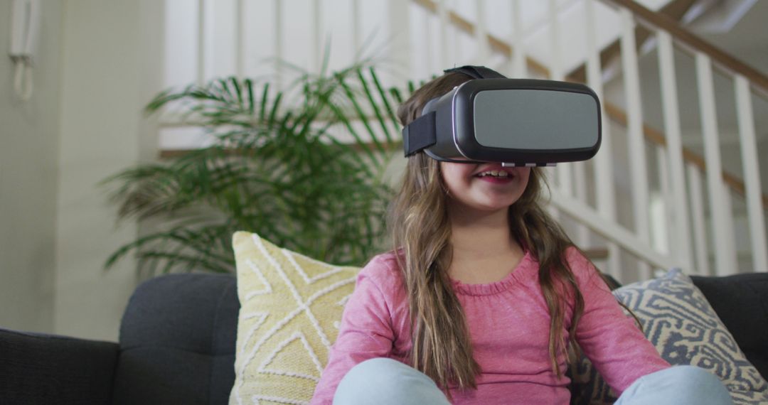 Girl Enjoying Virtual Reality Experience at Home - Free Images, Stock Photos and Pictures on Pikwizard.com