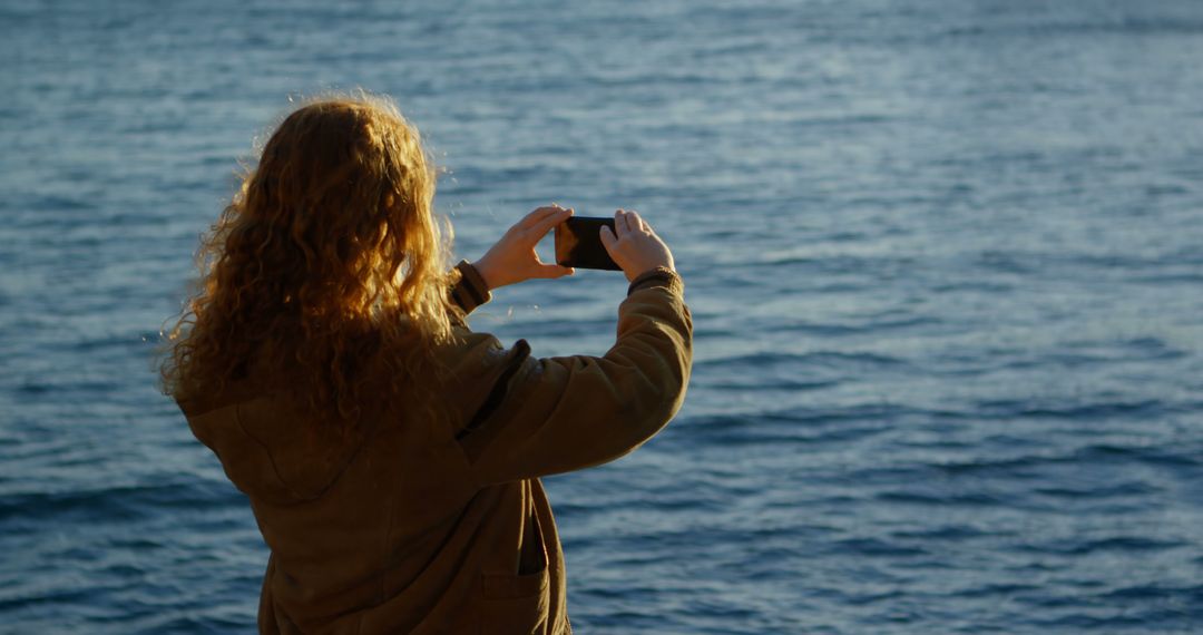 Woman Taking Photo of Ocean with Smartphone - Free Images, Stock Photos and Pictures on Pikwizard.com