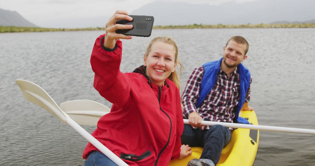 Young Couple Taking Selfie While Canoeing on Tranquil Lake - Free Images, Stock Photos and Pictures on Pikwizard.com