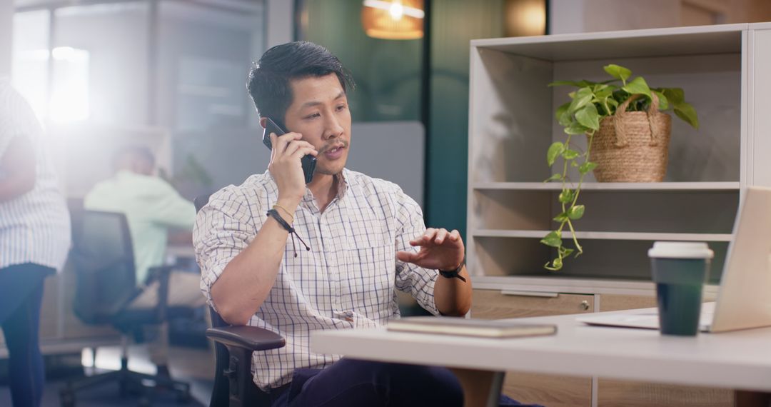Businessman Having Phone Conversation at Modern Office Desk