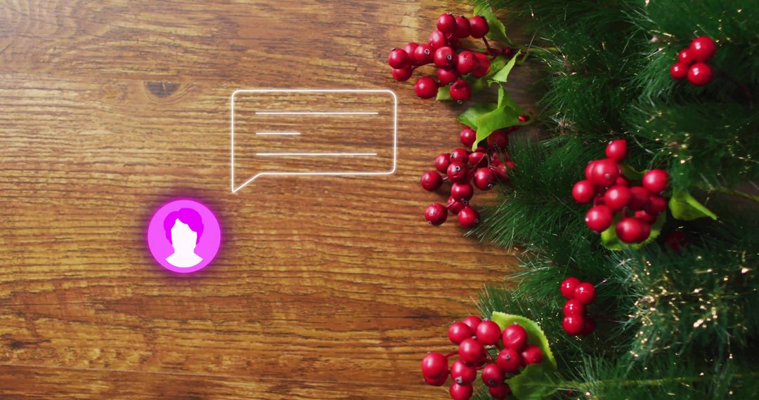 Sending seasonal message with evergreen garland and holly berries on wooden desk