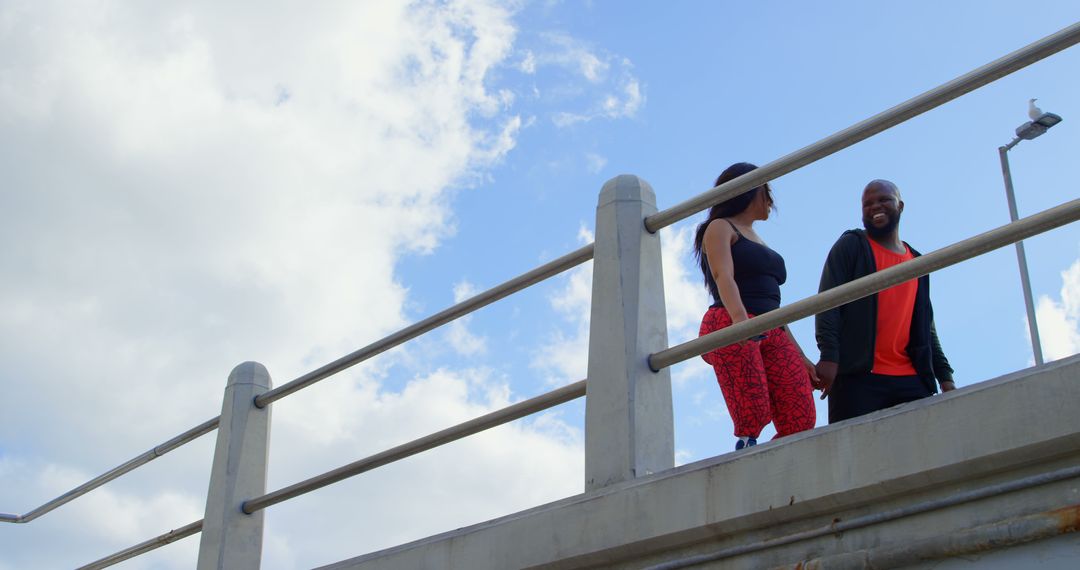 Couple Walking by Railing with Clear Sky