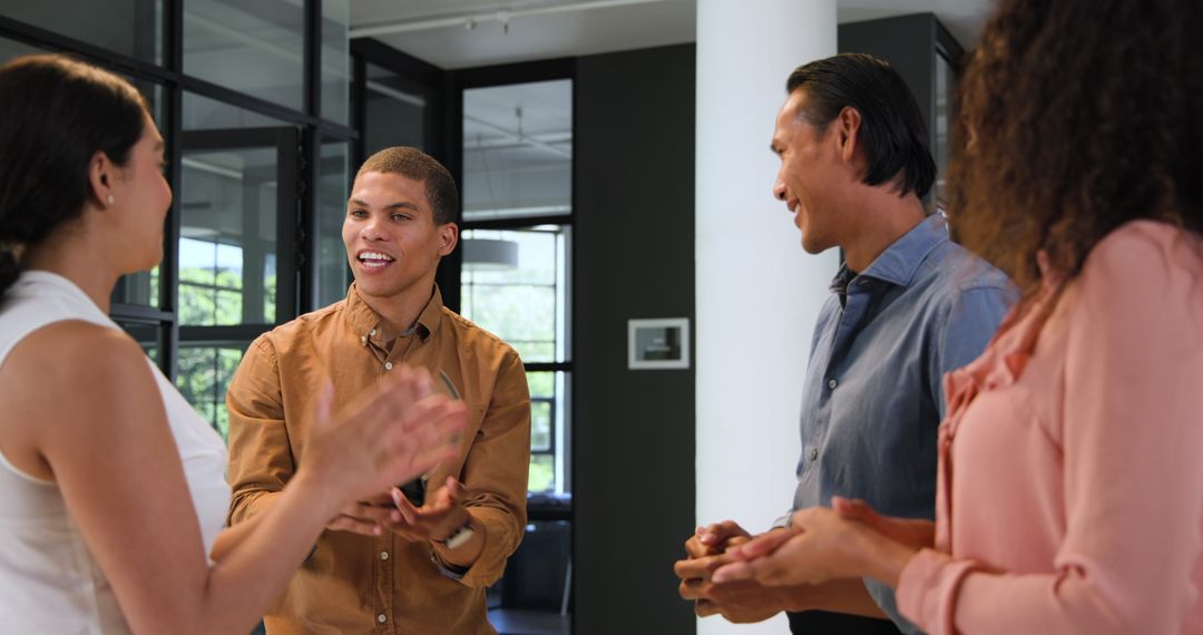 Diverse Team Celebrating Successful Collaboration in Office