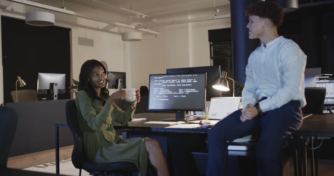 Diverse Team Collaborating on Programming in Modern Office Night Shift