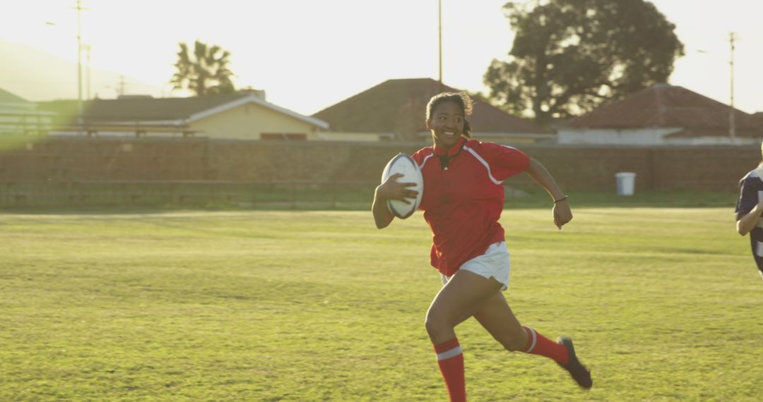 Female Rugby Player Charging Downfield at Sunset - Free Images, Stock Photos and Pictures on Pikwizard.com