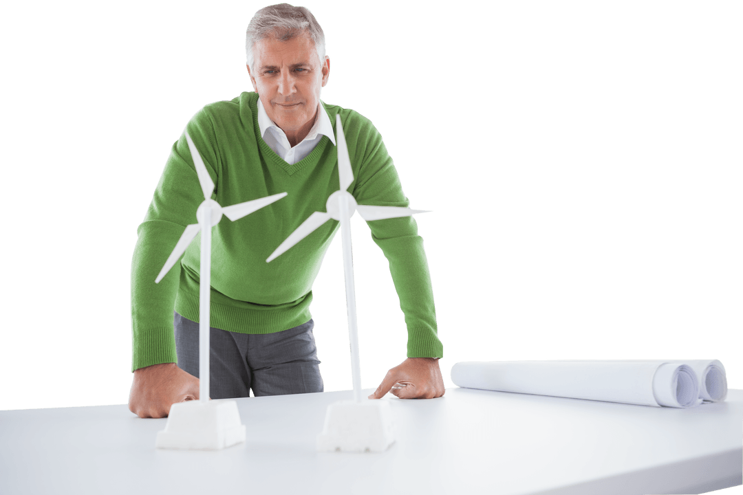 Engineer Analyzing Wind Turbine Models on Transparent Desk