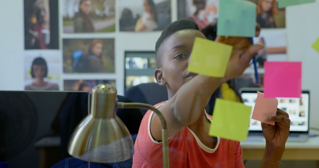 Focused Young African American Girl Organizing Colorful Sticky Notes at Desk - Free Images, Stock Photos and Pictures on Pikwizard.com