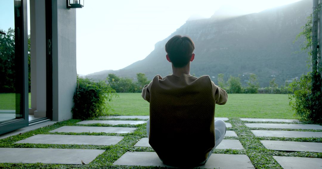 Man Enjoying Peaceful Mountain View from Modern Home