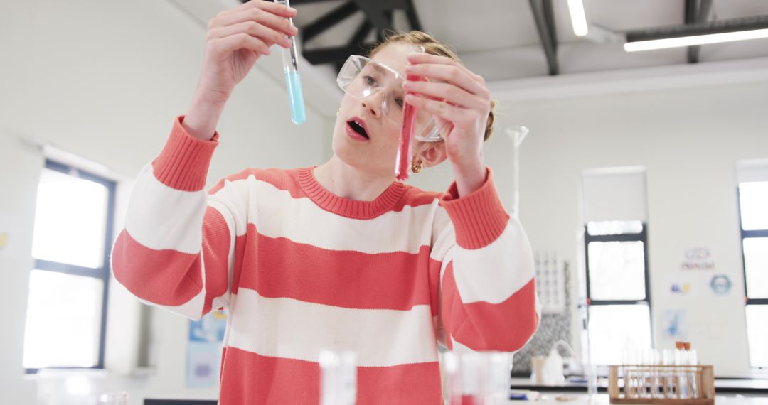 Young Student Conducting Experiment with Test Tubes in School Lab