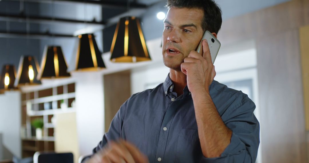 Businessman Having Phone Conversation in Modern Office - Free Images, Stock Photos and Pictures on Pikwizard.com