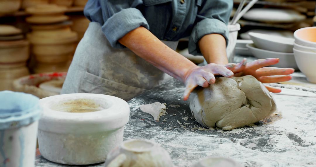 A person is skillfully shaping clay on a pottery wheel, with copy space - Free Images, Stock Photos and Pictures on Pikwizard.com