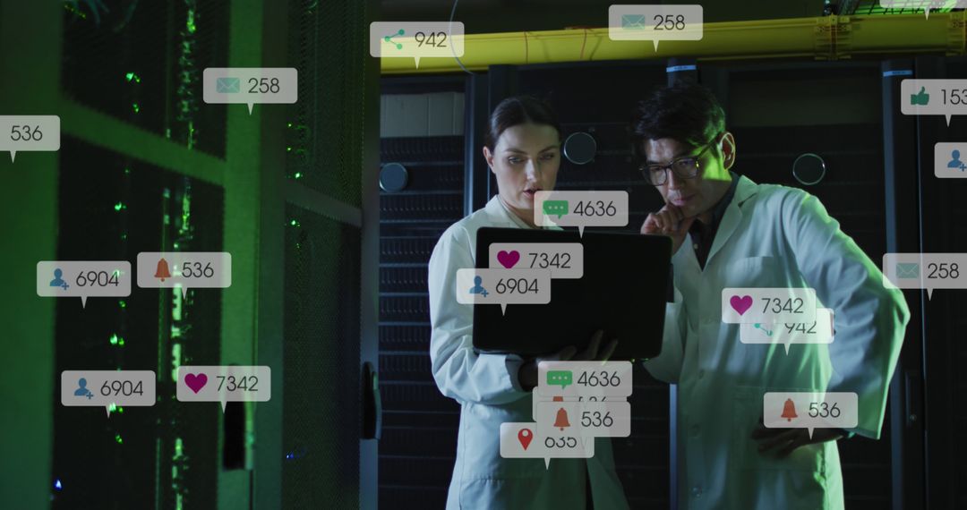 Scientists Analyzing Social Media Notifications on Laptop in Server Room - Free Images, Stock Photos and Pictures on Pikwizard.com