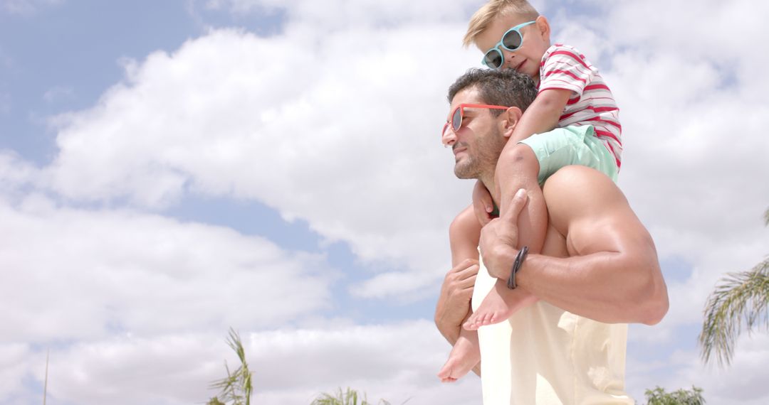 Father Carrying Young Son on Shoulders Outdoors Under Blue Sky - Free Images, Stock Photos and Pictures on Pikwizard.com