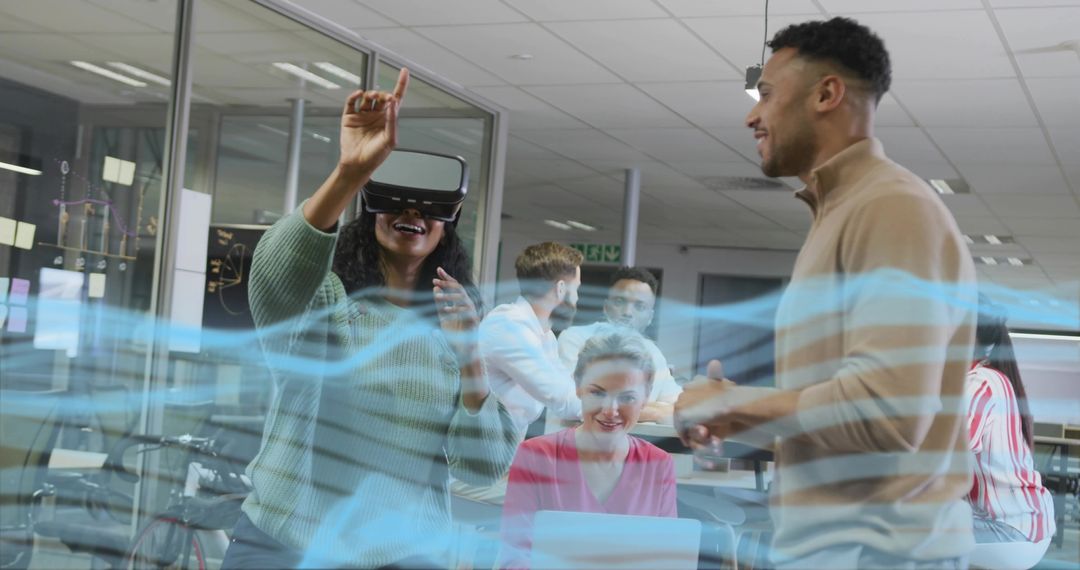 Team Experiencing Virtual Reality in Modern Office with Digital Interface