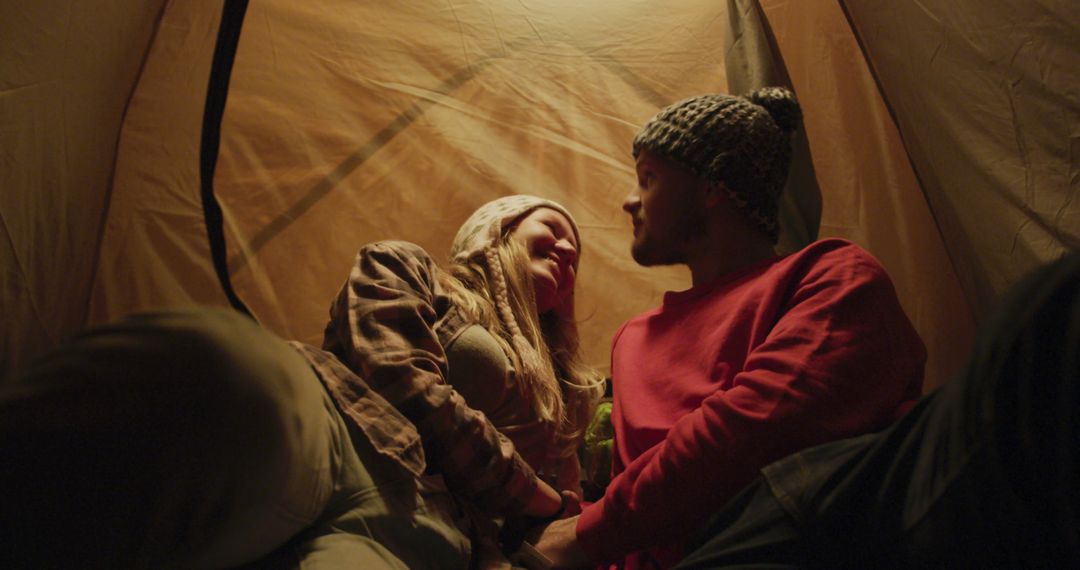 Couple Relaxing in Tent While Camping at Night