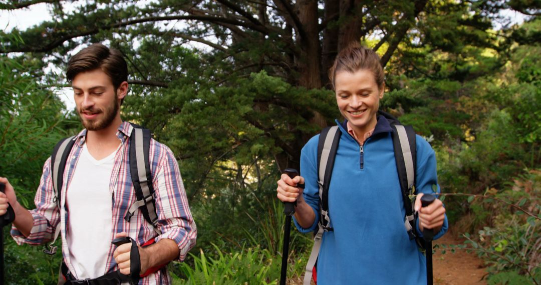 Young Hikers Exploring Lush Green Trails with Backpacks