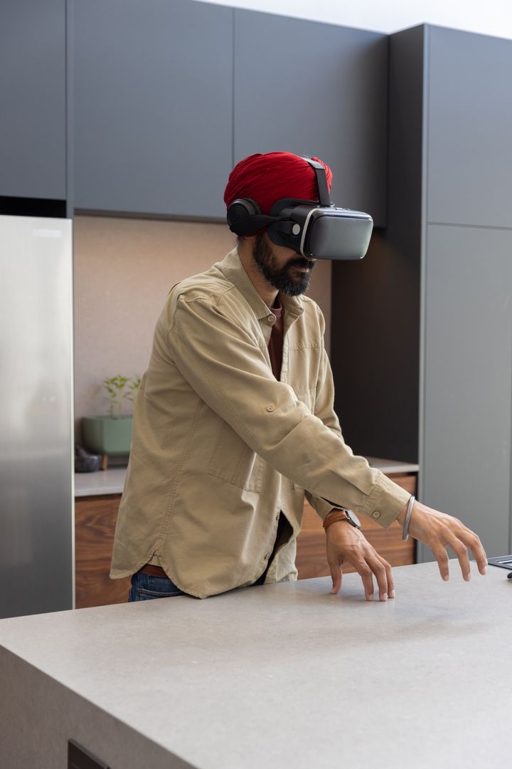 Man Experiencing Virtual Reality in Modern Kitchen Setting