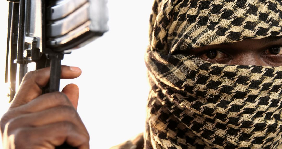 Masked Individual Holding Weapon With Intense Stare