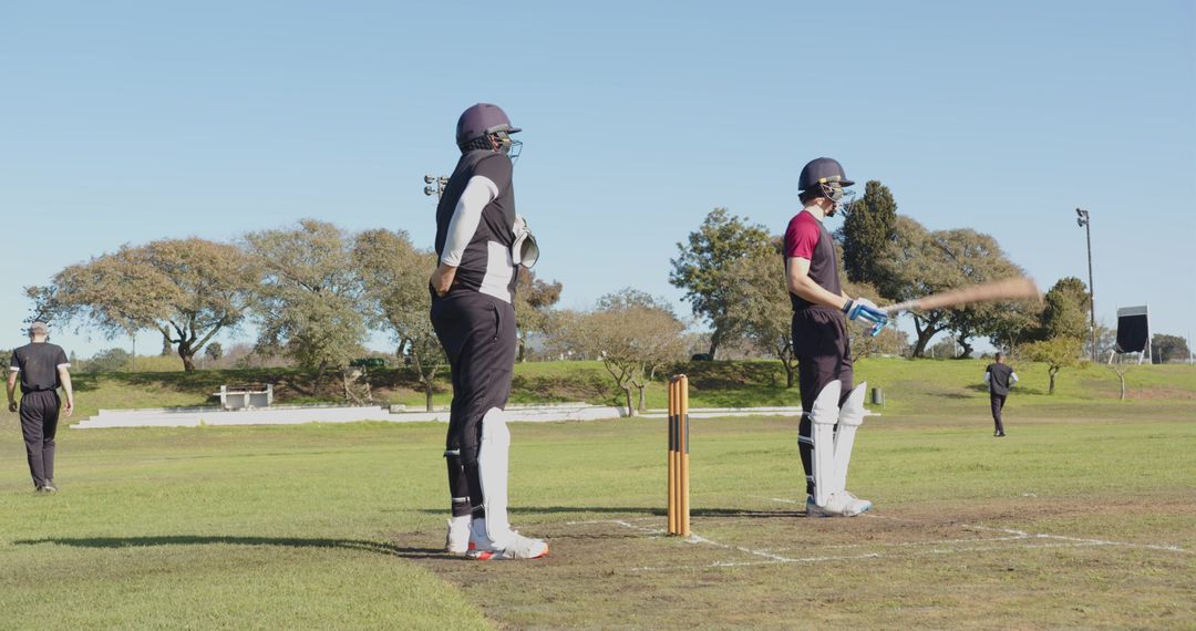 Cricket Players Training On Sunny Day in Protective Gear