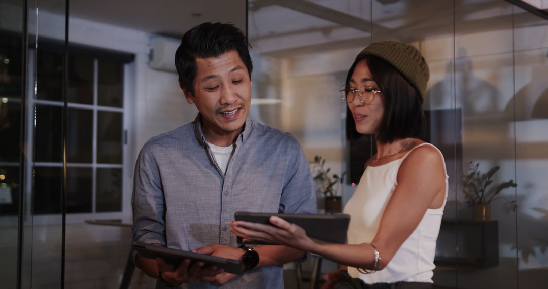 Diverse Professionals Collaborating on Digital Tablets in Office