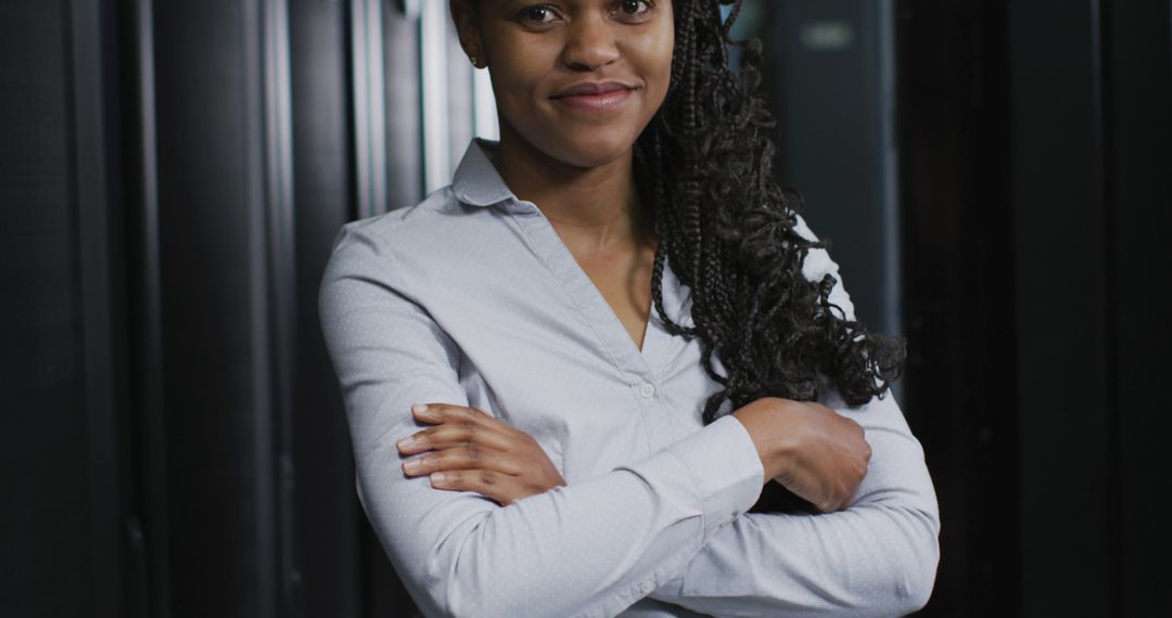 Confident African American Woman Standing with Arms Crossed in Office - Free Images, Stock Photos and Pictures on Pikwizard.com